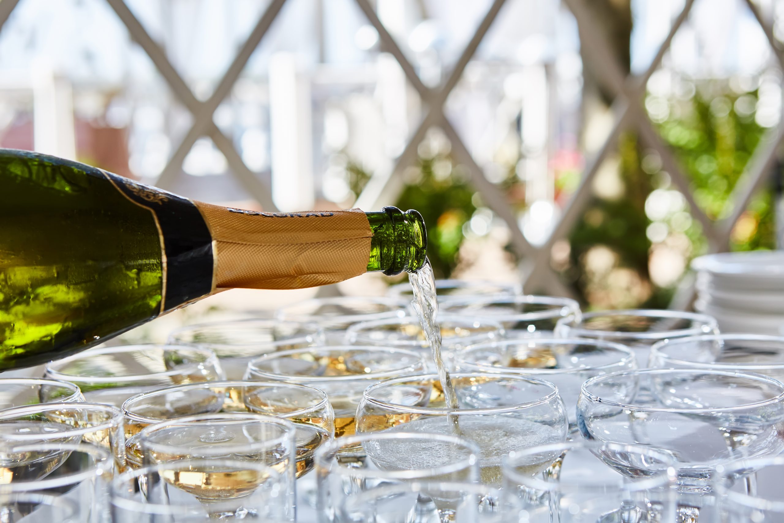 Champagne being poured into flutes on a table