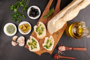 A Mediterranean spread of olives, olive oil, herbs and bread