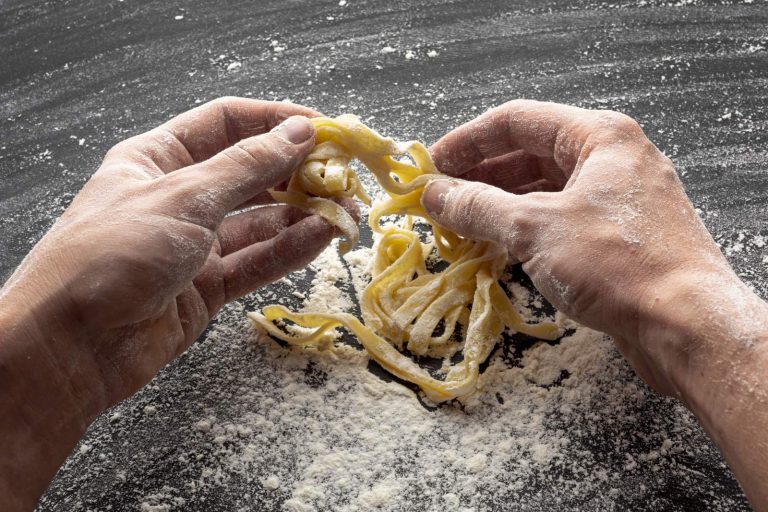 Making fresh tagliatelle by hand in a cooking class