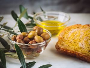 Bread with extra virgin olive oil and olives at a tasting