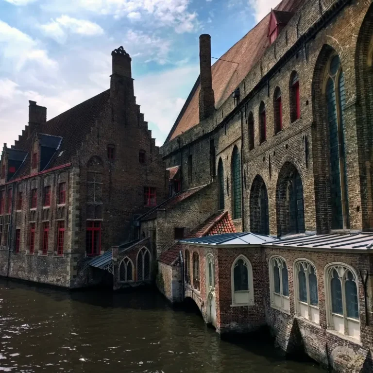 Medieval brick buildings along a canal in Bruges