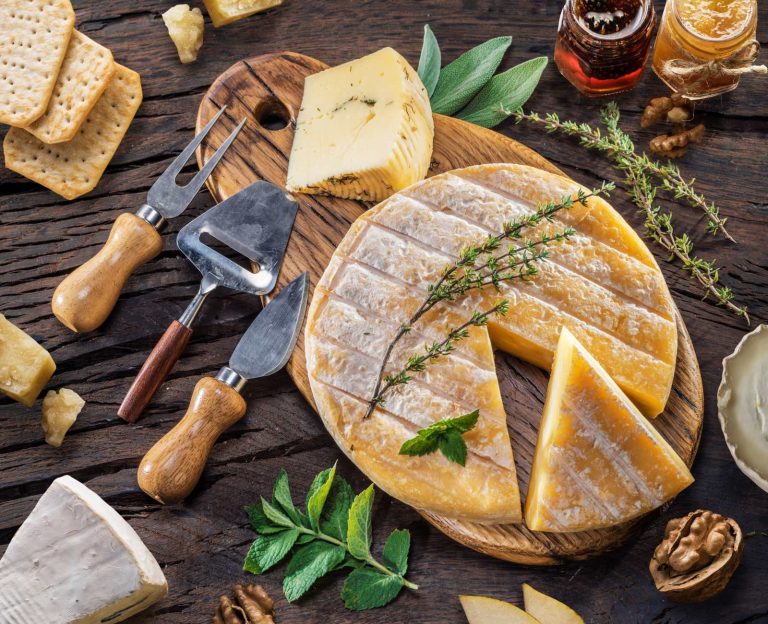 A wheel of sheep's milk cheese with herbs