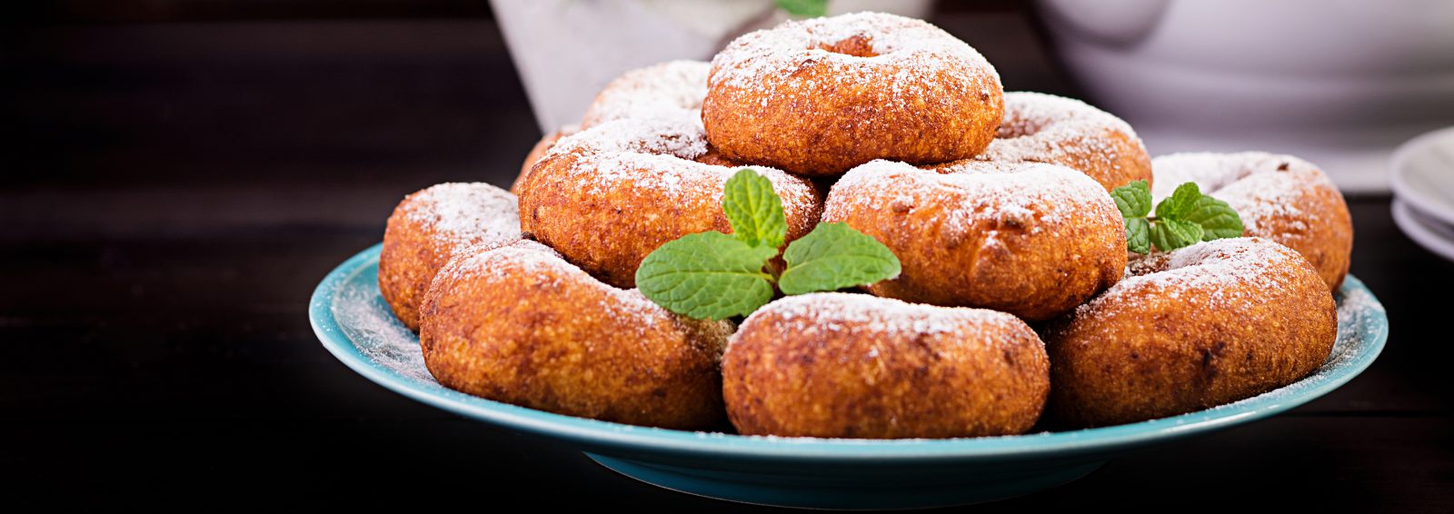 Small doughnuts dusted with powdered sugar, like Croatian fritule
