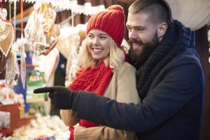Visitors at a wooden Christmas market stall