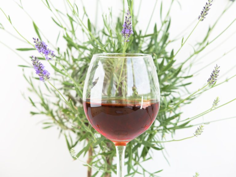 A glass of wine beside lavender, Provence