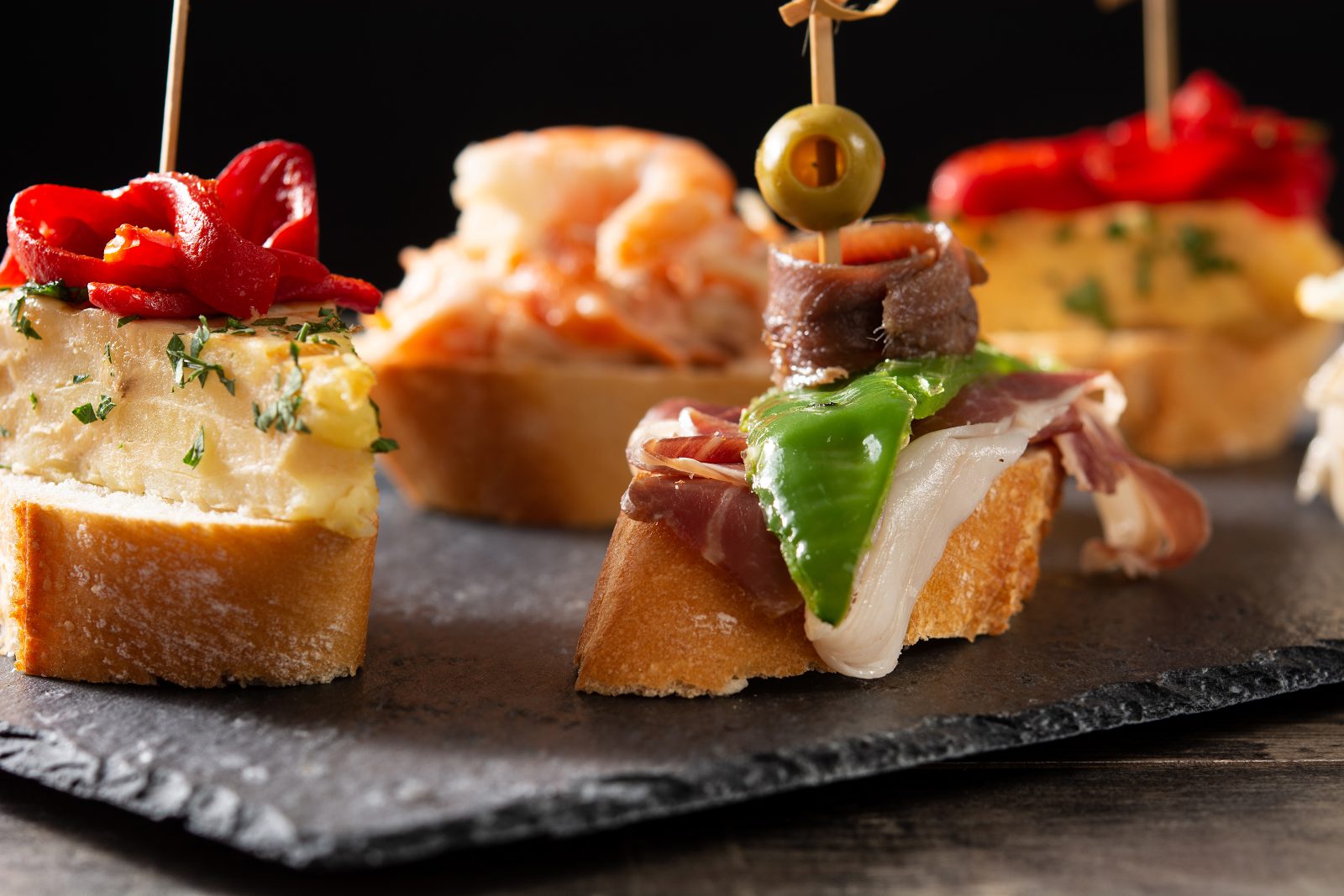 Assortment of Spanish pintxos on a bar counter, San Sebastian