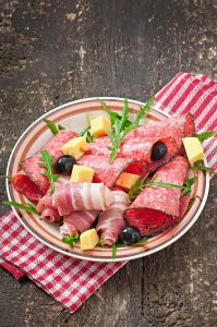 Cured meat platter on rustic wood, South Tyrol