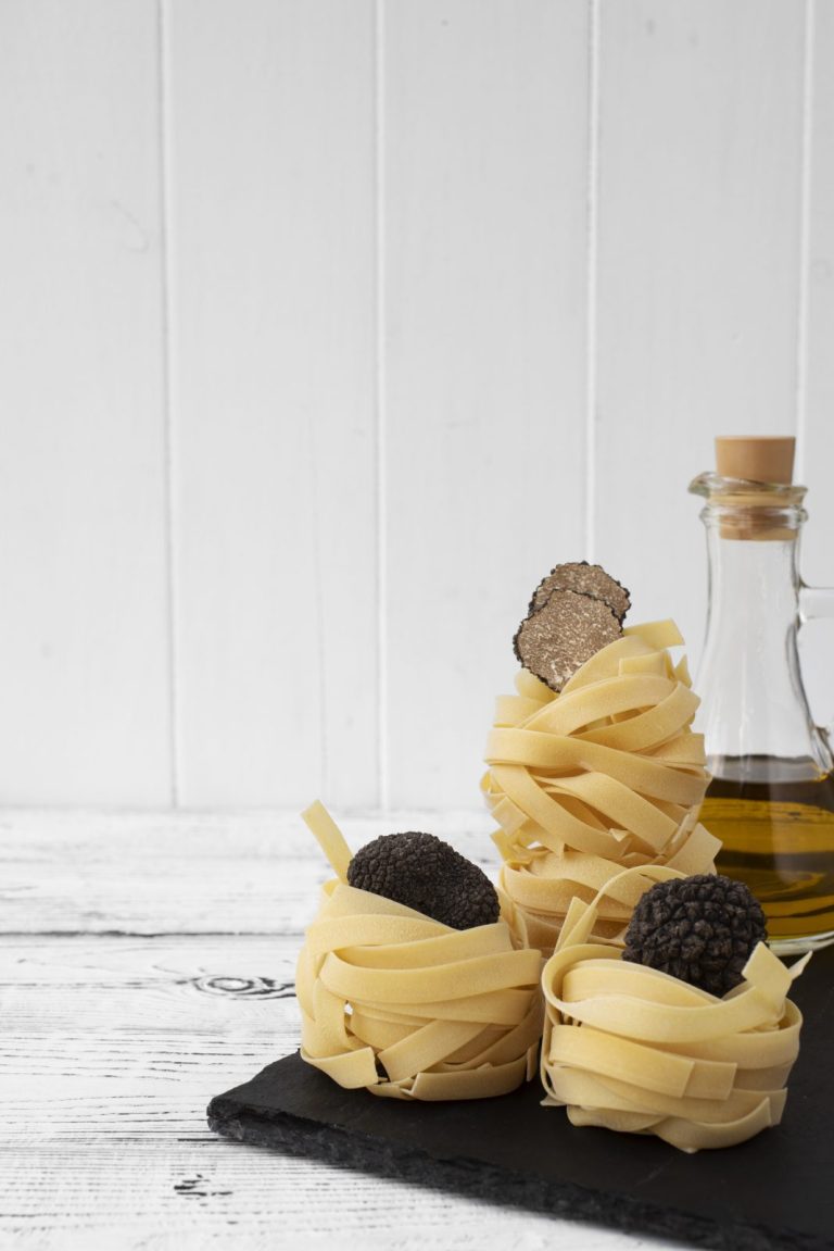 Fresh truffle with pasta on a rustic table, Tuscany