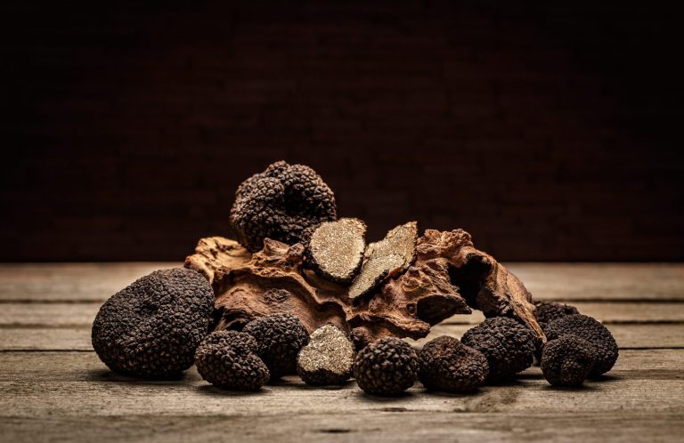 Black truffles on a rustic wooden table, Umbria