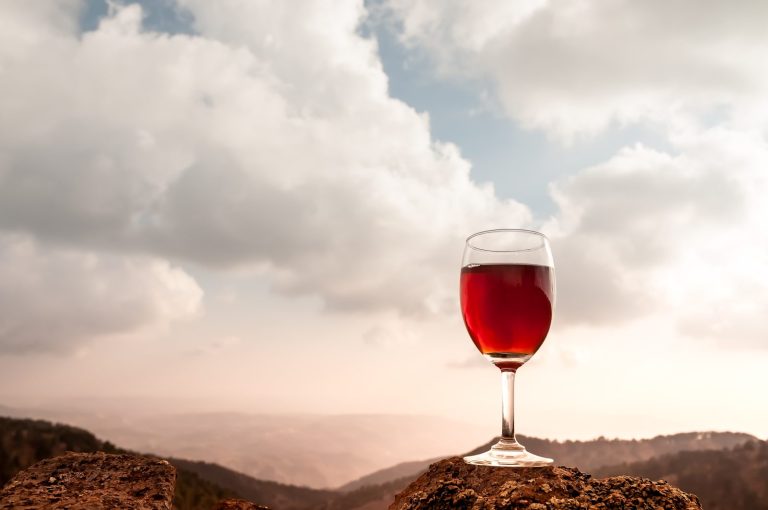 A glass of red wine in the autumn hills