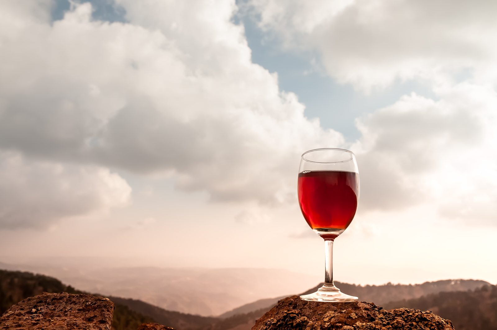 A glass of red wine in the autumn hills