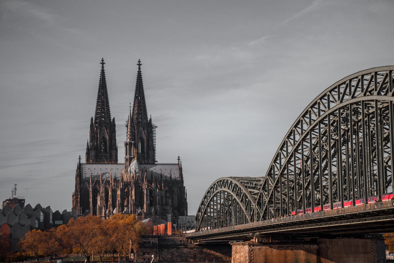 Gothic cathedral towers beside a steel bridge