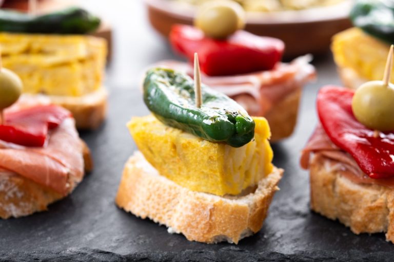 Pintxos on a bar counter, what to eat in San Sebastian