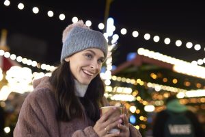 A cup of hot mulled wine at a Christmas market on a cold night